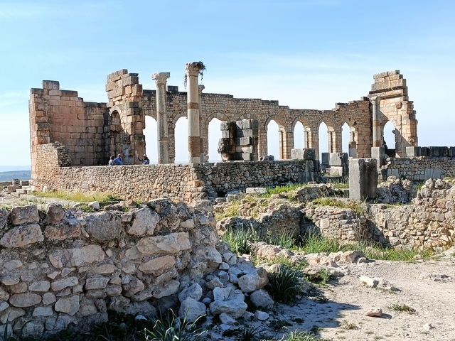       Ancient ruins with columns and stone structures.
  