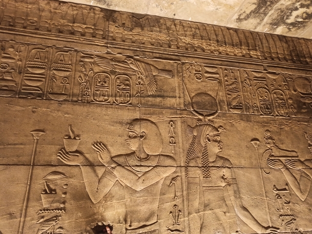       Close-up of ancient Egyptian hieroglyphs carved in stone.
  