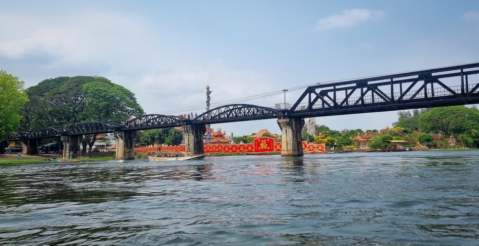       The iconic bridge over River Kwai with a scenic background.
  