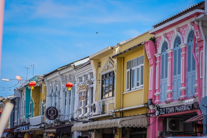       Colorful old town buildings with decorative shutters and lanterns
  