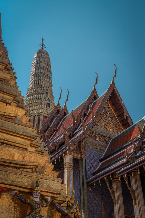       Ornate temple roof with gold embellishments and a spire
  