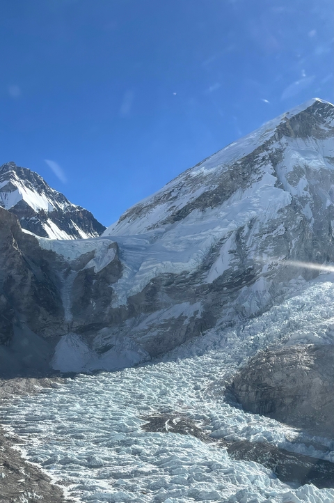       Majestic snow-covered mountain peaks under a clear blue sky.
  