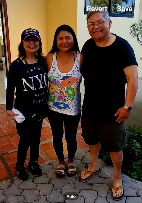 Three people posing together indoors.