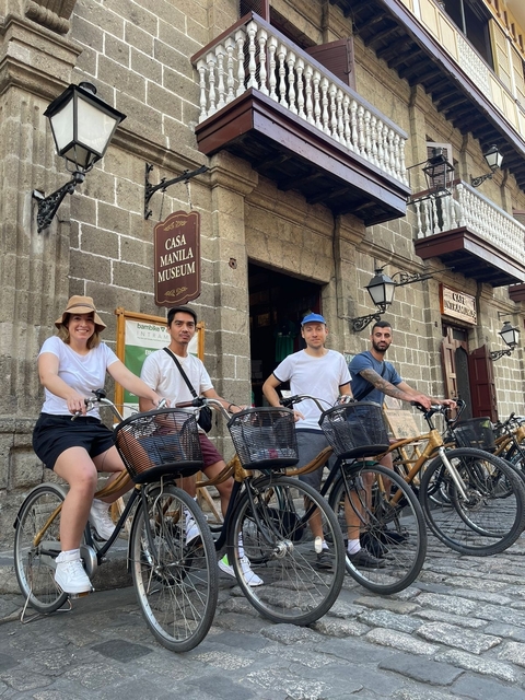       Group of people on bicycles in front of Casa Manila Museum.
  