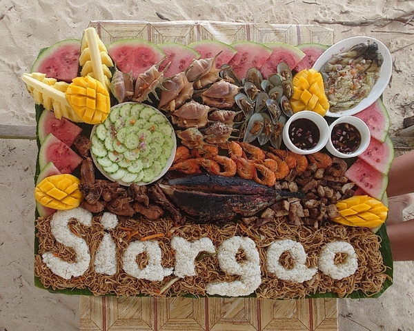 Colorful array of tropical fruits and seafood with the word 'Siargao'.