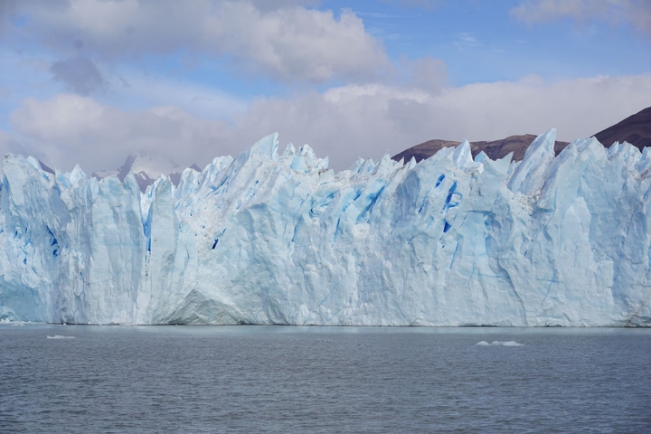 Massive glacier with jagged icy peaks.
