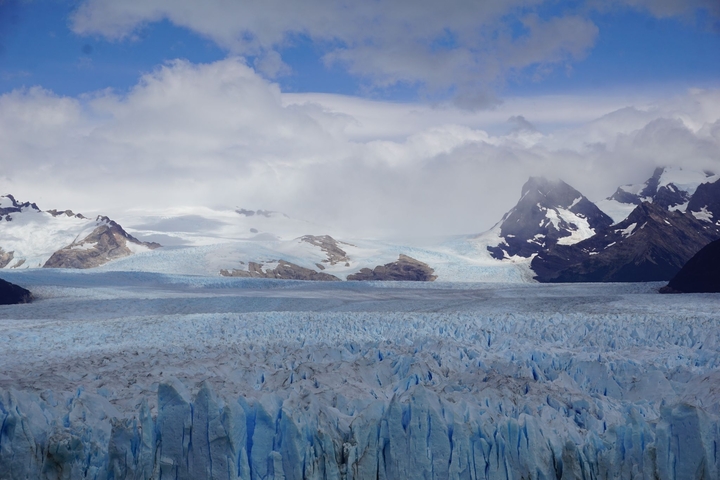 Expansive glacier field with surrounding mountains.