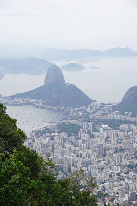 Aerial view of coastal city with iconic mountain.