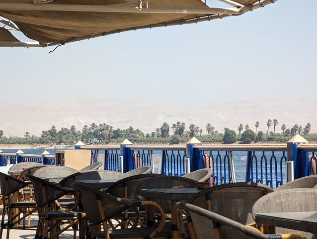 Riverside view from a deck with chairs.