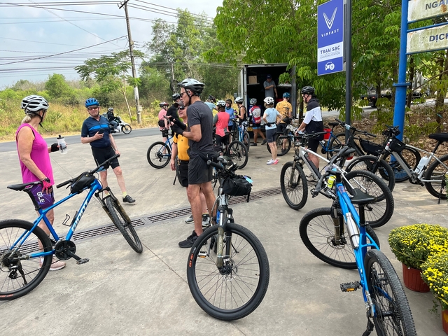 People gathering with bicycles ready for a ride.