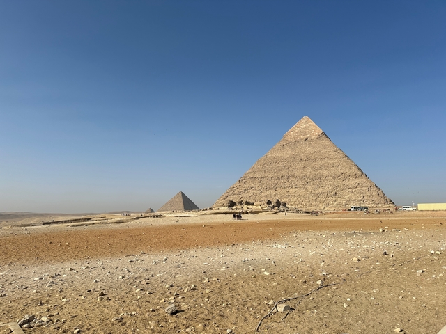 The Pyramids of Giza under a clear blue sky.