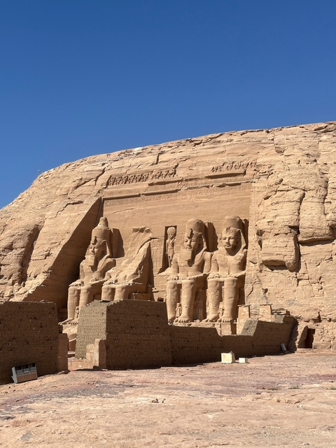       The rock-cut temples at Abu Simbel against a clear blue sky.
  