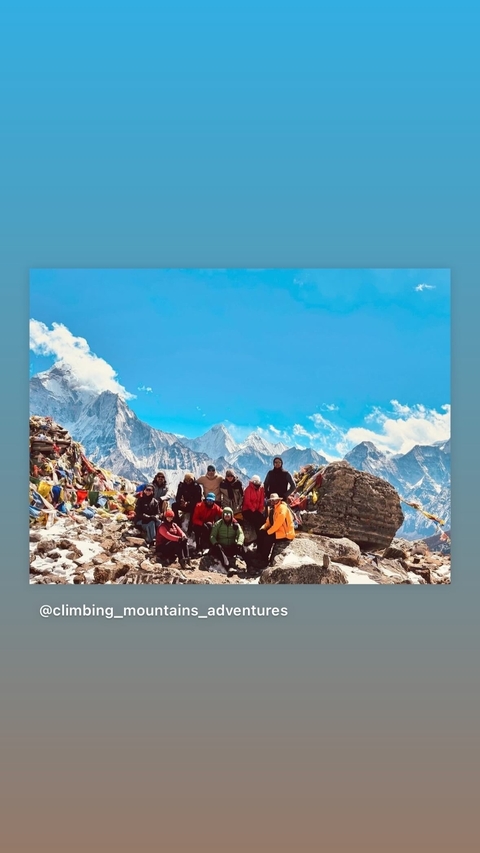       Group photograph with Himalayan mountain backdrop.
  