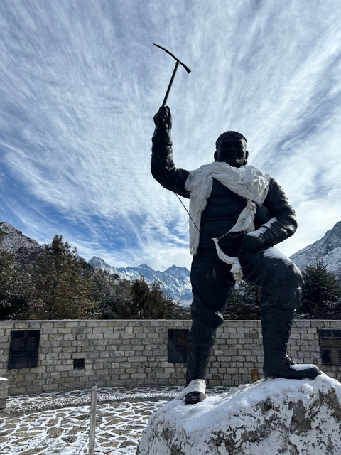       Statue with mountains in the background.
  