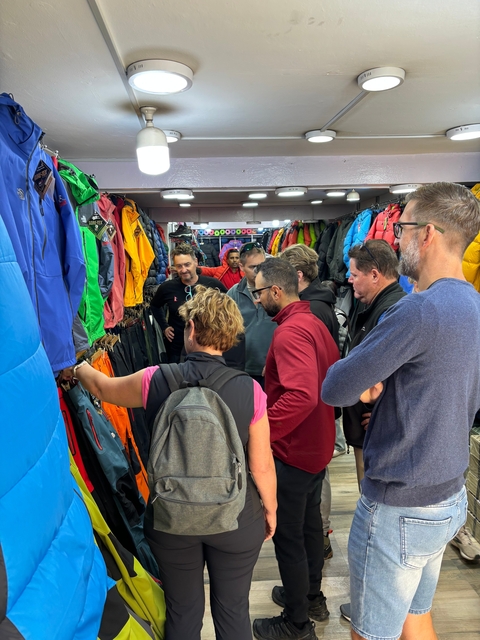       Group of people shopping for trekking gear.
  