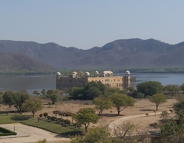 Palace in the middle of a lake with hills