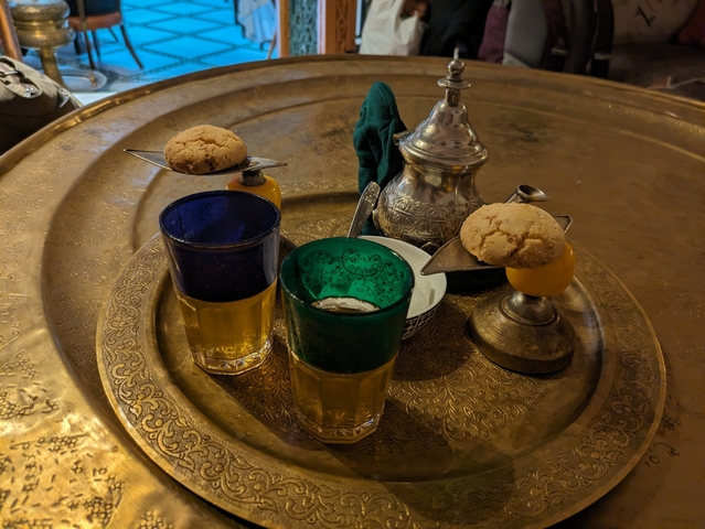 Tea served with Moroccan pastries on a tray.