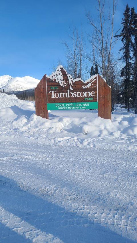 Sign for Tombstone Park in a snowy area.
