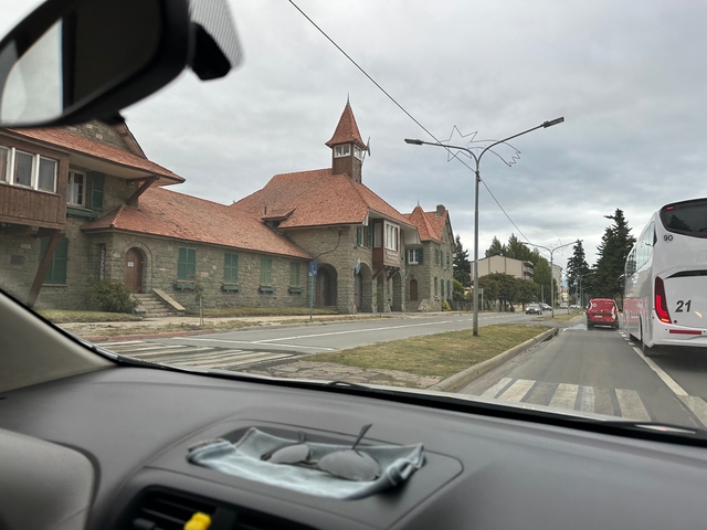       Street view with town buildings and parked cars.
  