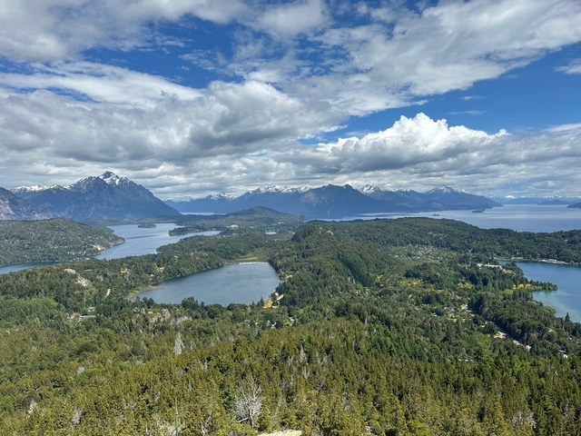       Scenic view of a mountainous landscape with lakes and forests.
  