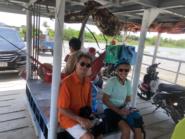 People on a small boat crossing a river.
