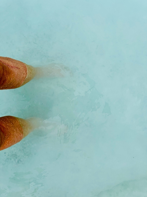 Close-up of feet in thermal waters.