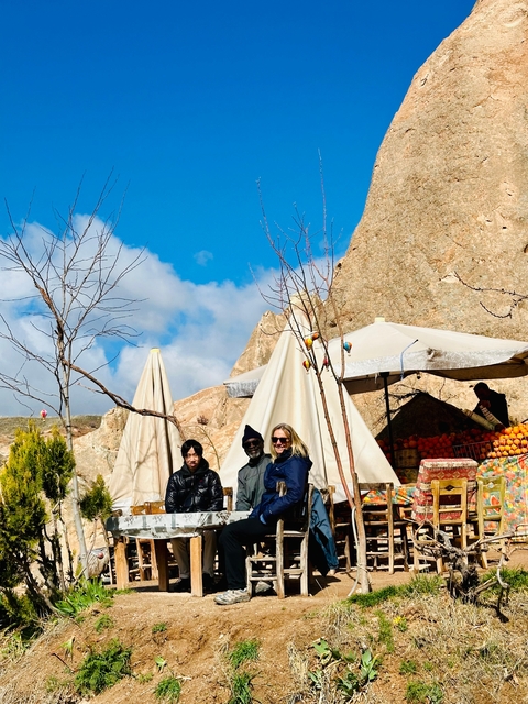       A group of people posing in an outdoor market setting.
  