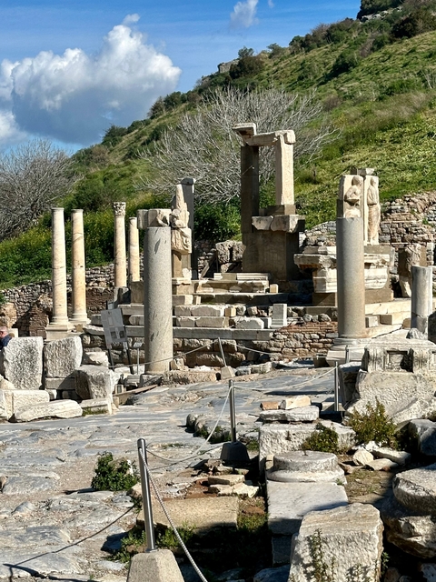       Ancient stone pillars and ruins on a sunny day.
  