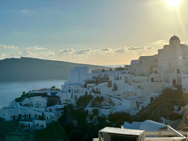 Santorini buildings at sunset with sea view.