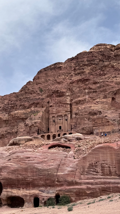 Ancient carved stone structures in a desert setting.