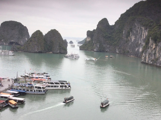       Scenic view of a bay with limestone rock formations and boats.
  