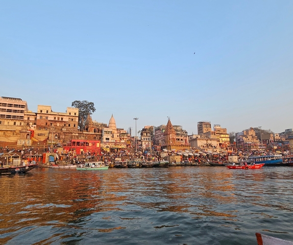       View of Varanasi ghats during the day from the river.
  