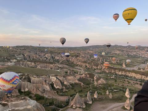       Hot air balloons soaring above Cappadocia's unique landscape.
  