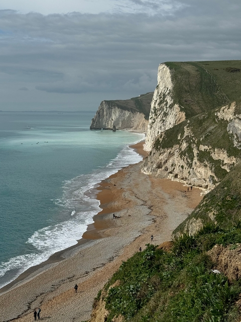 A coastal cliff with turquoise ocean waves below