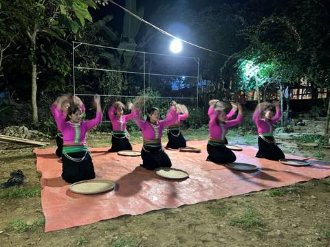 Group of performers dancing with circular objects