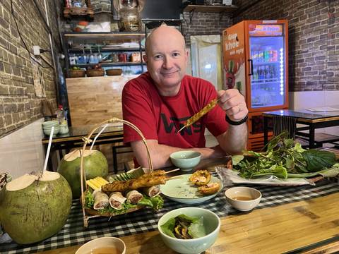       Man dining with seafood and coconut drinks
  