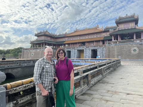       Two people posing in front of traditional architecture
  
