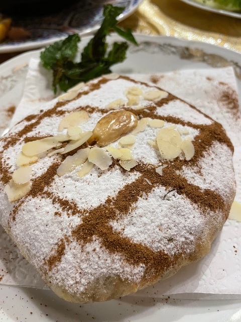       Close-up of a traditional Moroccan almond and powdered sugar pastry.
  
