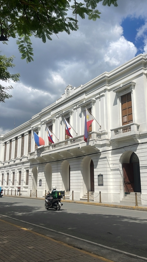 Historic building with flags in Manila.