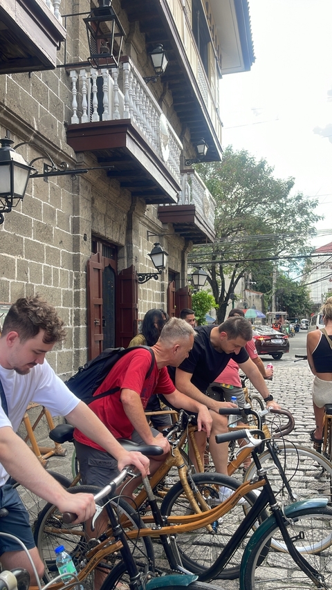 People gathered at a historic street in Manila.