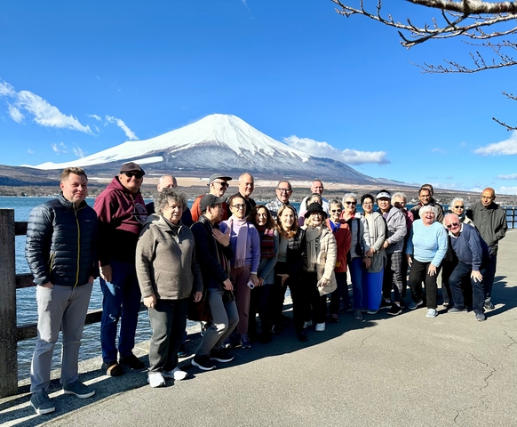 A group photo with Mount Fuji in the background.
