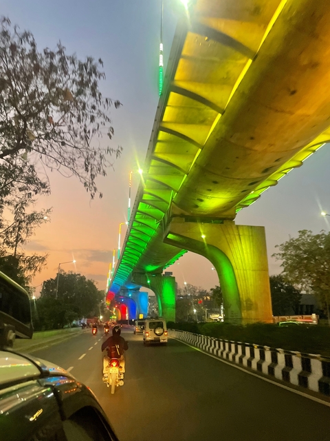       Illuminated bridge at night with colorful lighting.
  