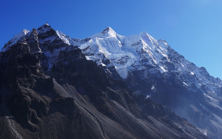       Snowy mountain peaks with clear blue sky.
  