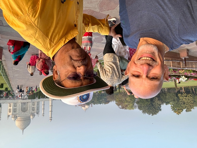 Two men posing in front of the Taj Mahal.