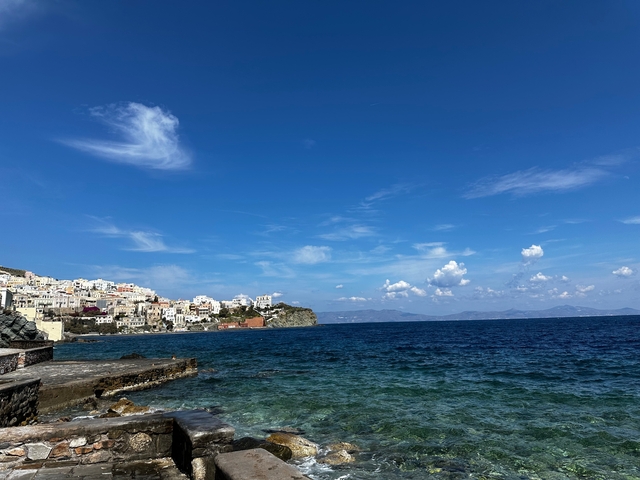 Coastal town view with blue sea under a blue sky.