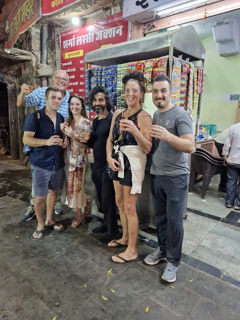       People enjoying drinks on a street.
  