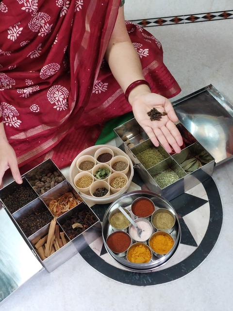       Selection of various spices laid out for cooking.
  