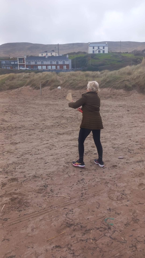 Person playing sports on a sandy beach.