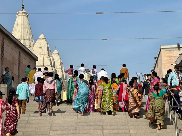       Crowd ascending steps towards a temple.
  