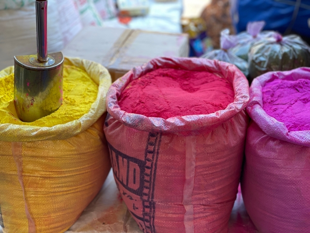 Brightly colored powders in large sacks.